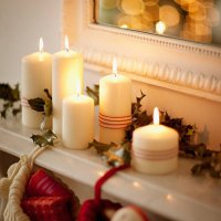 candles lit on mantelpiece with christmas stockings - home decoration stock pictures, royalty-free photos & images