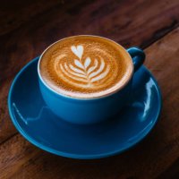 cappuccino in a blue ceramic mug on a wooden table side view - coffee stock pictures, royalty-free photos & images