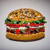 capsules and pills in shape of hamburger - junk food stock pictures, royalty-free photos & images