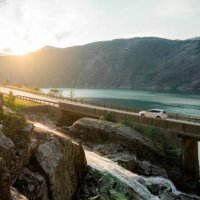 car on bridge across the river in norway - travel stock pictures, royalty-free photos & images