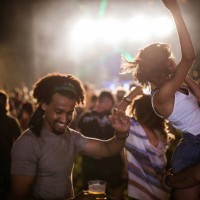carefree couple and their friends having fun on music festival by night. - concert stock pictures, royalty-free photos & images