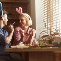 carefree couple having fun on easter in dining room. - home decoration stock pictures, royalty-free photos & images