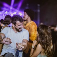 carefree couple having fun while dancing on music festival by night. - concert stock pictures, royalty-free photos & images
