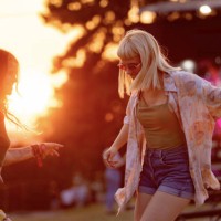 carefree female friends dancing during a music festival at sunset. - concert stock pictures, royalty-free photos & images
