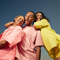 carefree friends standing against sky - fashion stock pictures, royalty-free photos & images