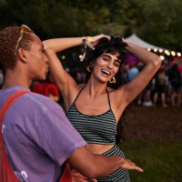 carefree multiracial couple dancing together - concert stock-fotos und bilder