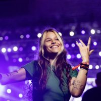 carefree woman having fun while dancing on a music festival at night. - concert stock pictures, royalty-free photos & images