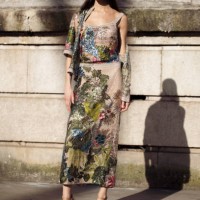 Carol Mendes wears beige and multicolour sheer knitted sequin top with with matching skirt and short sleeve blouse or sweater and beige bandana...