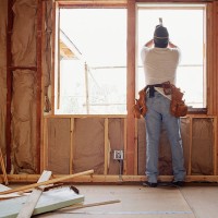 carpenter working on window at house renovation site, rear view - home decoration stock pictures, royalty-free photos & images