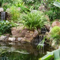 cascade fountain in the garden. man-made fountain, cascading water from stones. - garden decoration stock pictures, royalty-free photos & images