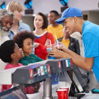 cashier giving drinks to customers at concession stand - junk food stock pictures, royalty-free photos & images