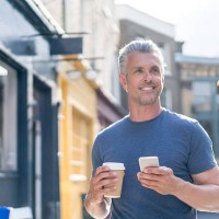 casual man walking on the street - junk food stock pictures, royalty-free photos & images