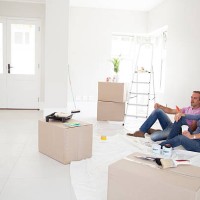 caucasian couple relaxing in new home - home decoration stock pictures, royalty-free photos & images