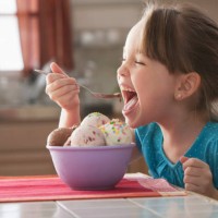 caucasian girl eating bowl of ice cream - junk food stock pictures, royalty-free photos & images