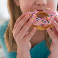 caucasian girl eating donut - junk food stock pictures, royalty-free photos & images