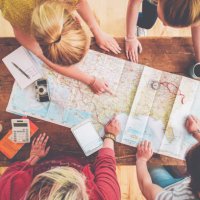 caucasian women planning trip with map on wooden table - travel stock pictures, royalty-free photos & images
