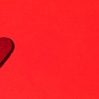 ceramic red heart, on the left side, on red background. concept of love, friendship and passion. - garden decoration stock pictures, royalty-free photos & images