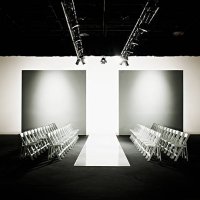 chairs around catwalk set for fashion show - fashion week stock pictures, royalty-free photos & images