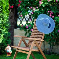 chaise lounge chair at the garden with a hat on it - garden decoration stock pictures, royalty-free photos & images