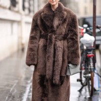 Charlotte Groeneveld wears a brown oversized fluffy fur coat, a gray Hermes Kelly bag, outside Hermes, during the Womenswear Fall/Winter 2024/2025 as...