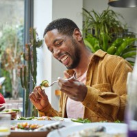 cheerful black man having lunch with family - food stock pictures, royalty-free photos & images