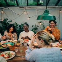 cheerful business colleagues having dinner together in garden - food stock pictures, royalty-free photos & images