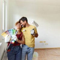 cheerful couple having fun during home renovation process. - home decoration stock pictures, royalty-free photos & images