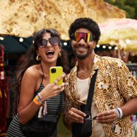 cheerful couple trying sunglasses at market stall - concert stock pictures, royalty-free photos & images