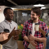 cheerful diverse colleagues chatting during coffee break - junk food stock pictures, royalty-free photos & images