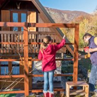 cheerful father and daughter painting wooden fence on sunny autumn day - home decoration stock pictures, royalty-free photos & images