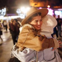 cheerful female friends hugging in amusement park in the evening - concert stock pictures, royalty-free photos & images