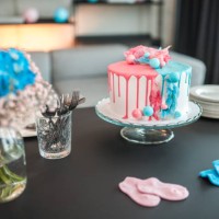 cheerful gender reveal party with beautifully decorated cake - home decoration stock pictures, royalty-free photos & images