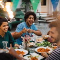 cheerful male and female friends enjoying during dinner party in backyard - garden decoration stock pictures, royalty-free photos & images
