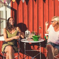 cheerful mature female friends enjoying summer in back yard on sunny day - garden decoration stock pictures, royalty-free photos & images