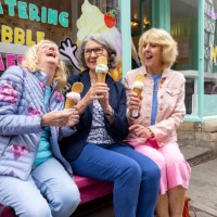 cheerful mature woman eating ice cream together - junk food stock pictures, royalty-free photos & images
