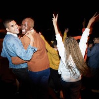 cheerful men dancing with friends at night - fashion stock pictures, royalty-free photos & images