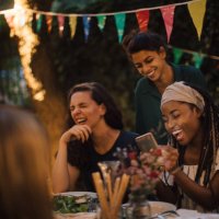 cheerful multi-ethnic friends enjoying at table during dinner party in backyard - garden decoration stock pictures, royalty-free photos & images