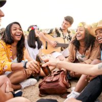 cheerful multiethnic group of friends gathering at the beach. - concert stock pictures, royalty-free photos & images