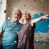 cheerful senior couple among confetti during home renovation process. - home decoration stock pictures, royalty-free photos & images