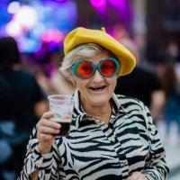 cheerful senior enjoying outdoor night concert in city. - concert stock pictures, royalty-free photos & images