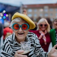 cheerful senior friends enjoying outdoor night concert in city. - concert stock pictures, royalty-free photos & images