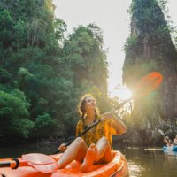 cheerful woman sea kayaking among karst formations and mangrove forest on krabi - travel stock pictures, royalty-free photos & images