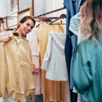 cheerful woman shopping for clothes in boutique store - fashion stock pictures, royalty-free photos & images