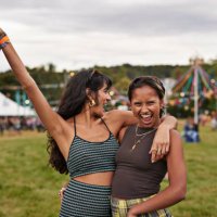 cheerful woman shouting while standing with female friend - concert stock pictures, royalty-free photos & images