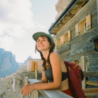 cheerful woman standing on the porch of mountain hut in dolomites - travel stock pictures, royalty-free photos & images