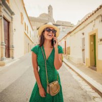 cheerful woman talking on her smartphone - travel stock pictures, royalty-free photos & images