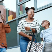 cheerful young friends against window at college - fashion stock pictures, royalty-free photos & images