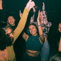 cheerful young friends dancing and enjoying together at nightclub - concert stock pictures, royalty-free photos & images