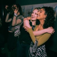 cheerful young women embracing while enjoying at nightclub - concert stock pictures, royalty-free photos & images
