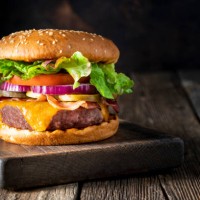 cheeseburger burger patty classic on rustic board of wood - junk food stock pictures, royalty-free photos & images